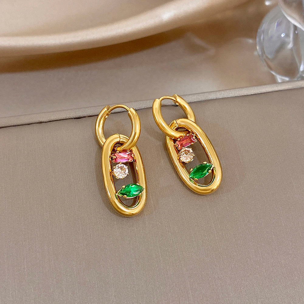 Gold hoop earrings with multicolor gem accents: red, green, and clear stones