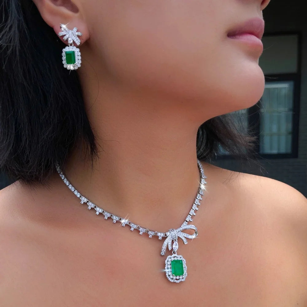 Green CZ bow pendant necklace with green rectangle dangle earrings in silver-tone