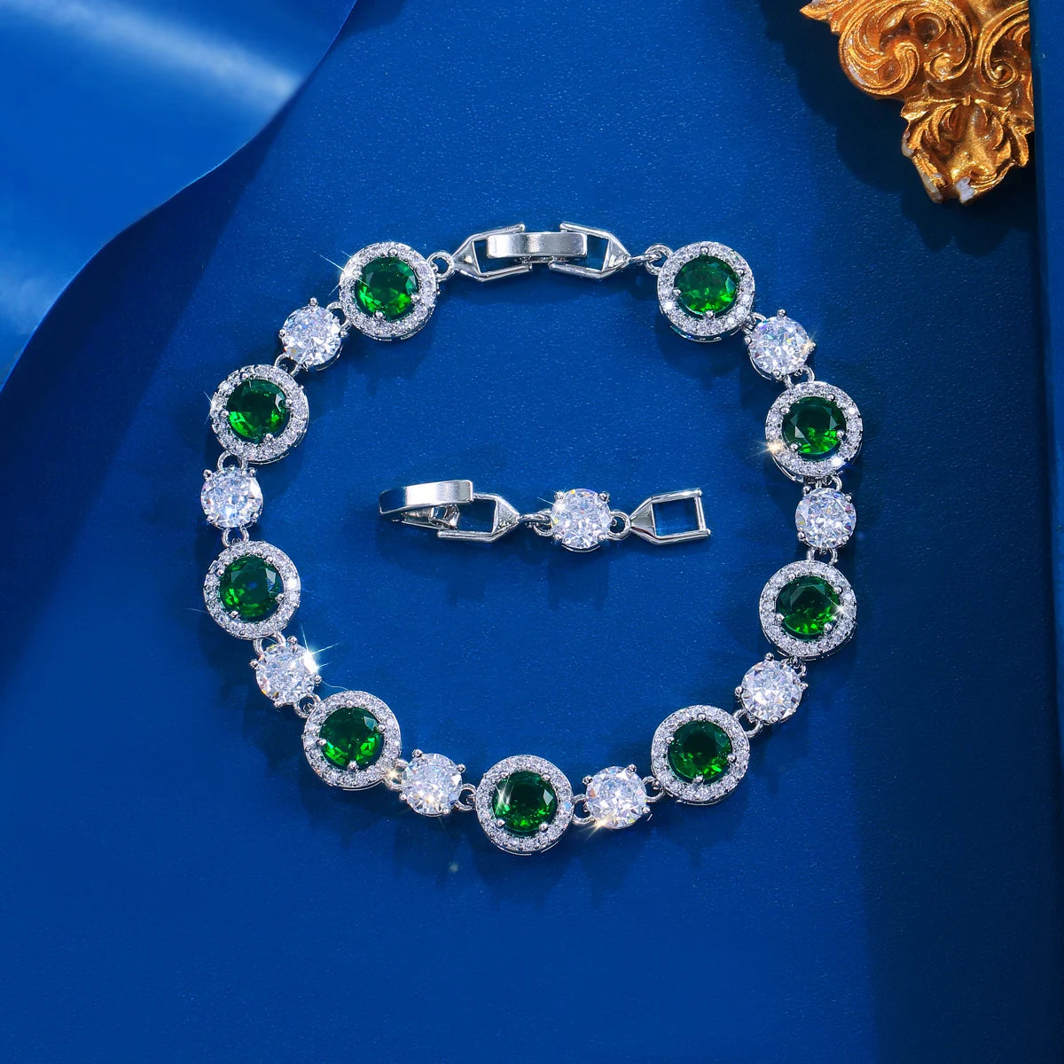 Silver-tone tennis bracelet with round green stones alternating with clear stones