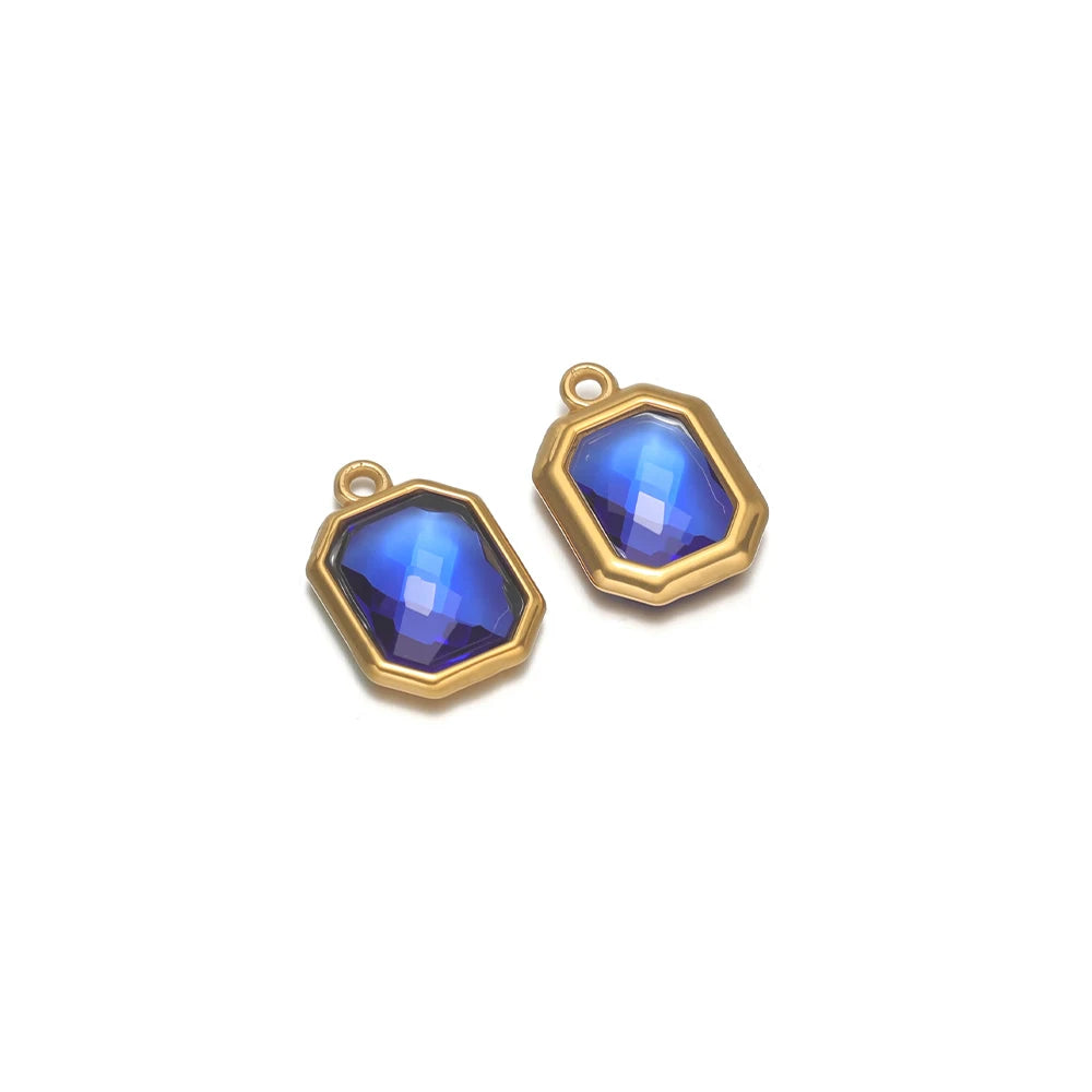 Dark blue faceted glass octagon charm connector with gold-tone loop, stainless steel