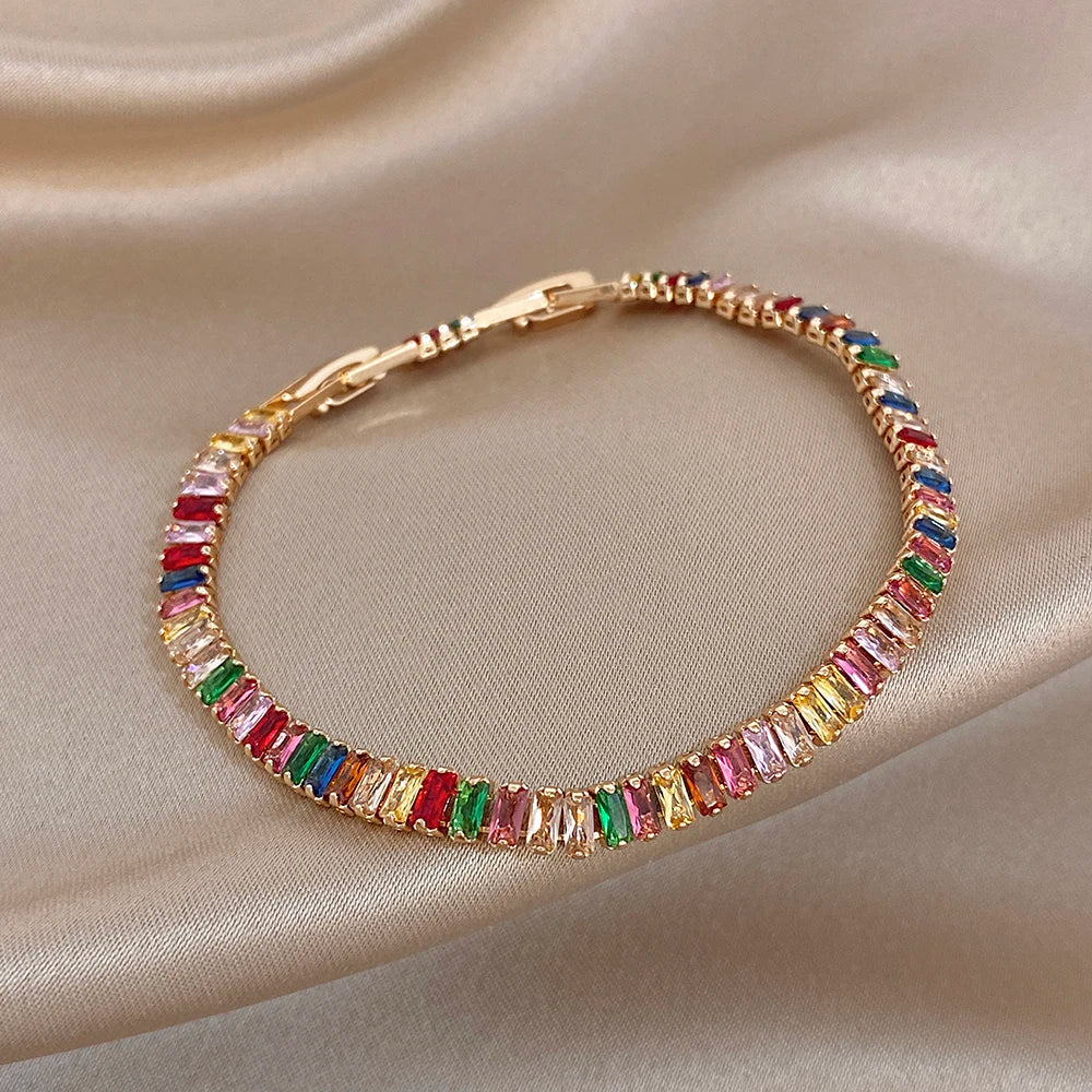 Gold-tone rainbow zircon tennis bracelet, close view of baguette stone band
