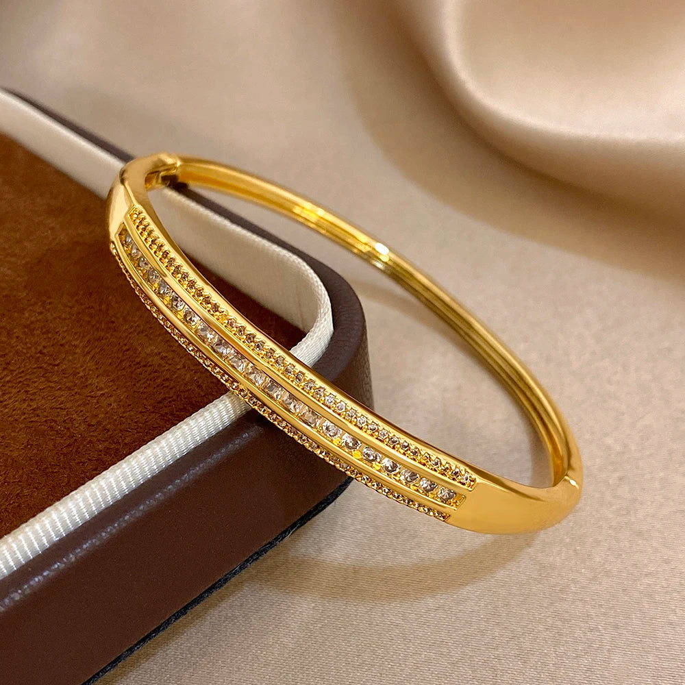 Gold-plated wide cuff bangle with two micro zircon rows and a geometric divider stripe