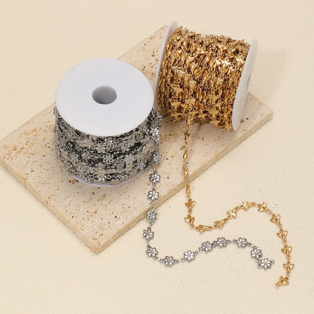 Silver and gold sea-animal charm chain spools with loose chain strands