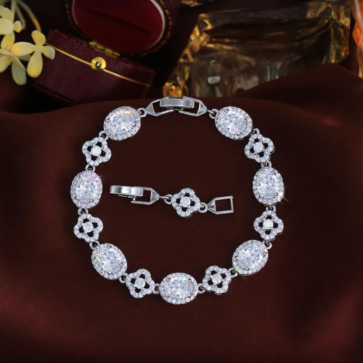 Clear oval crystal flower tennis bracelet arranged in a circle with clasp