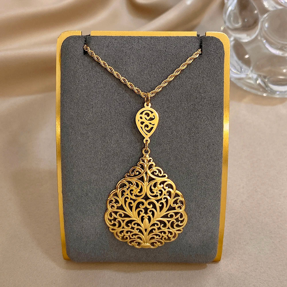 Gold-tone filigree teardrop pendant necklace with heart charm detail