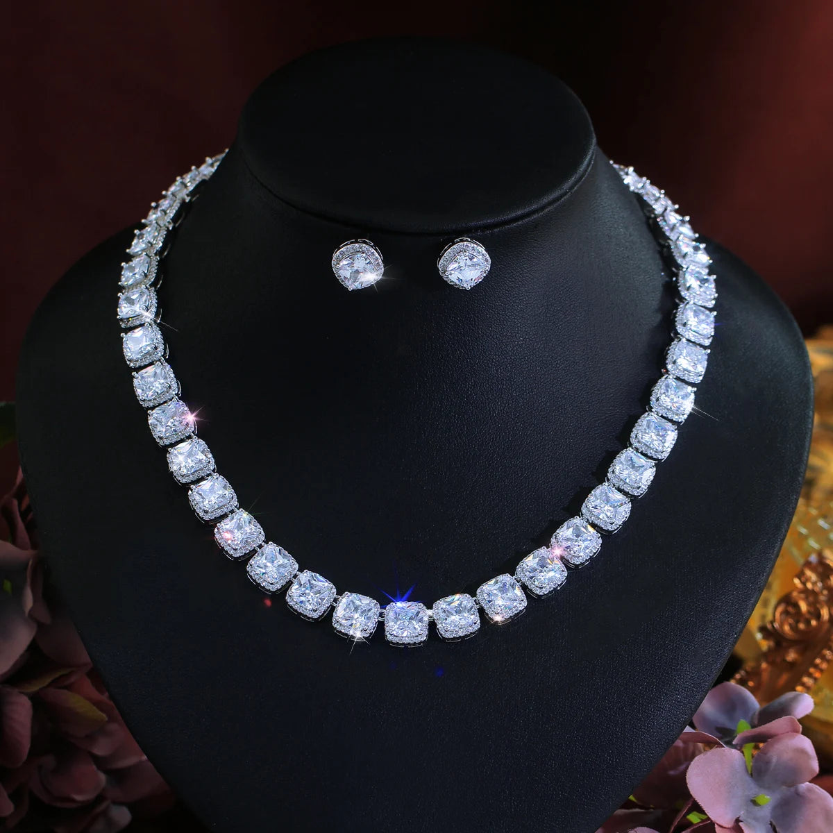 White square zirconia necklace and matching stud earrings on a display bust
