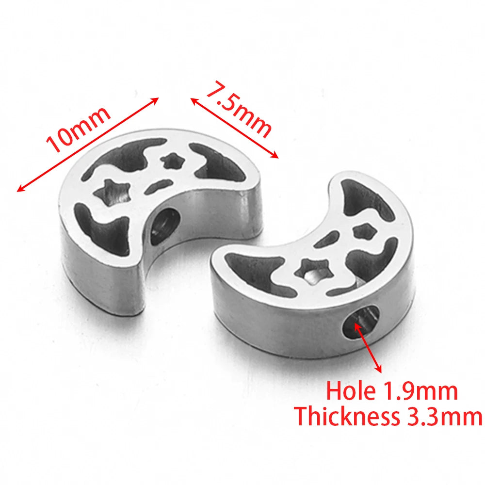 Silver-tone round stainless steel spacer beads with paw-style cutouts, pair view
