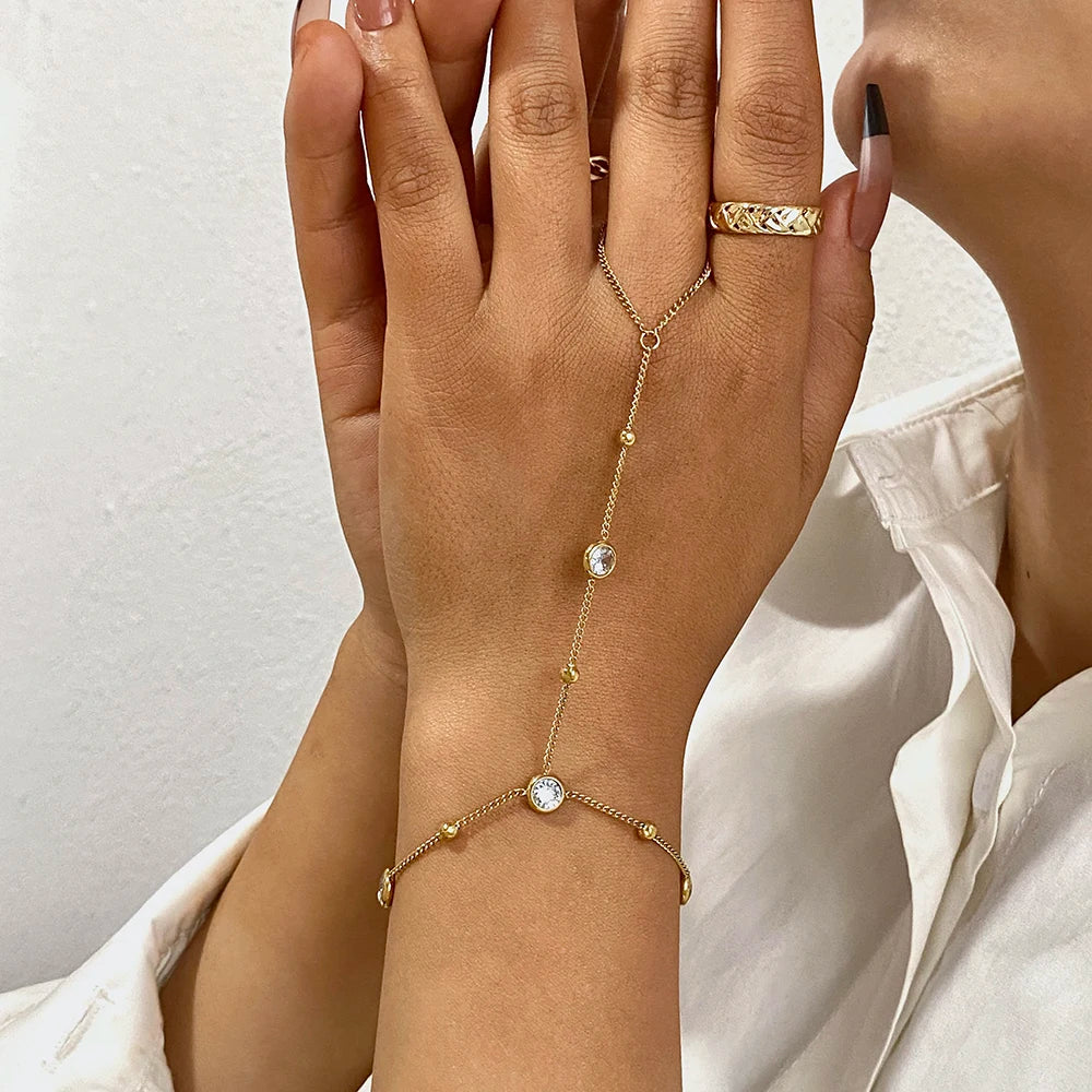 Gold-plated chain bracelet with round zircon beads on wrist and finger ring