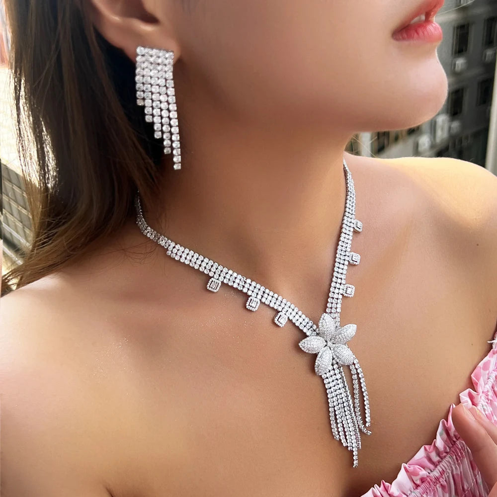 Crystal flower pendant necklace with cascading tassels and matching dangle earrings, close view