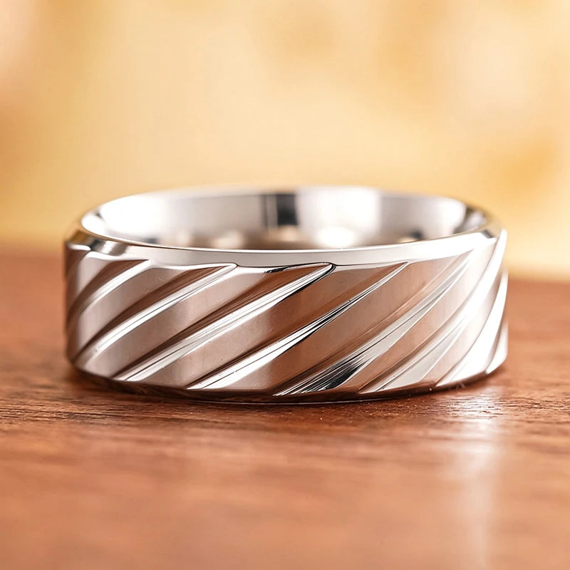 Stainless steel diagonal groove band ring with curved profile and sculpted diagonal ridges