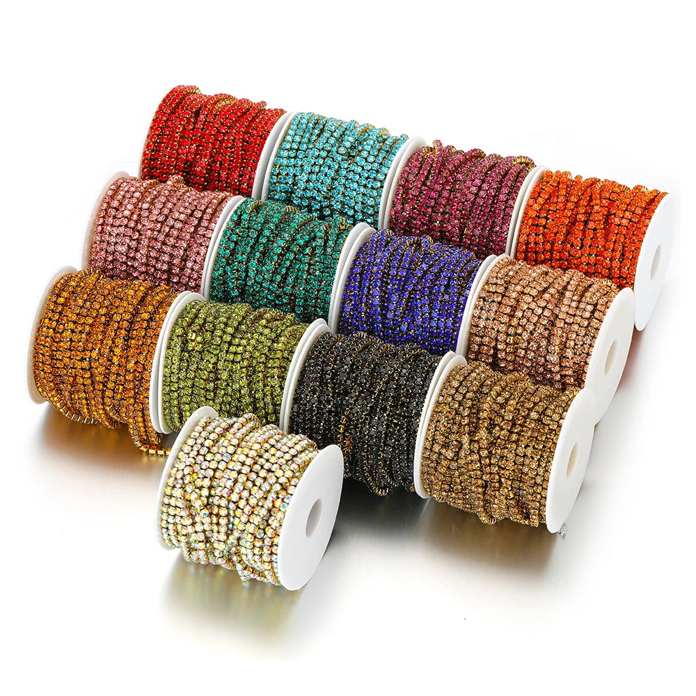 Assorted rhinestone crystal chain tassel spools in red, teal, navy, brown, gold, and green