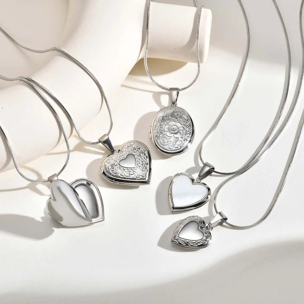 Silver heart pendant necklace set with engraved heart charms on thin chains
