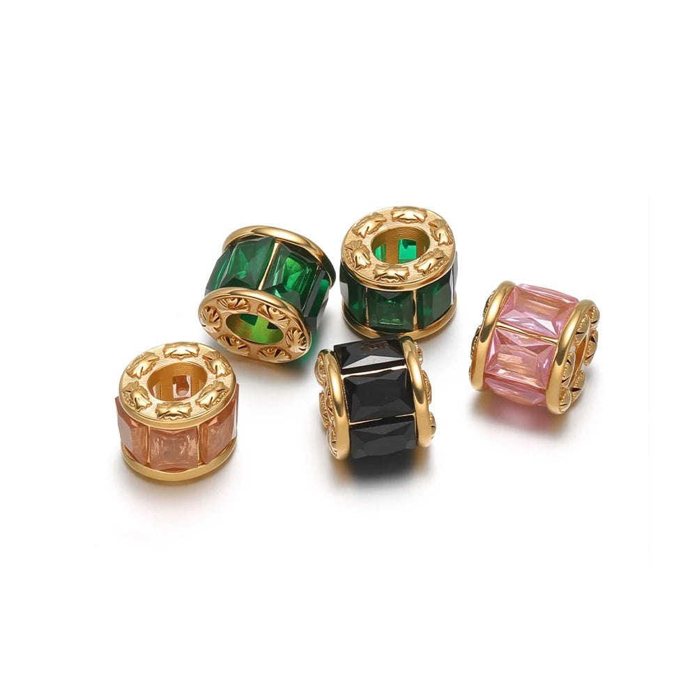 Gold-plated spacer beads with green, black, peach, and pink crystal accents