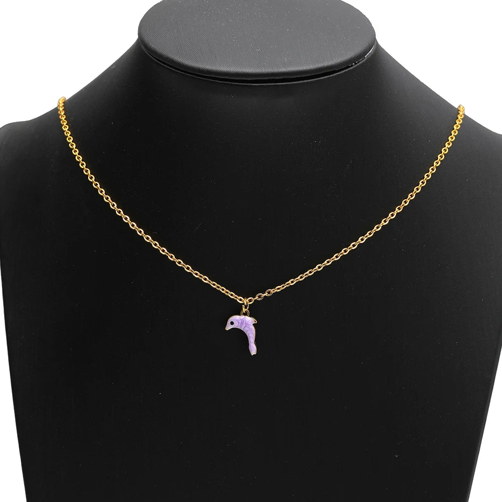 Gold-tone necklace with a small purple enamel dolphin charm pendant