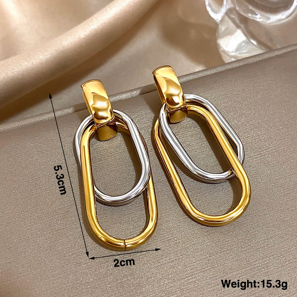 Mixed-metal oval drop earrings with 5.3 cm length and 2 cm width measurements