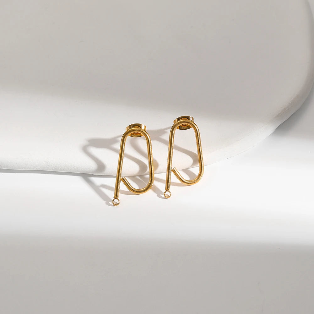Gold long stick ear wire hooks connectors, close-up of two pairs