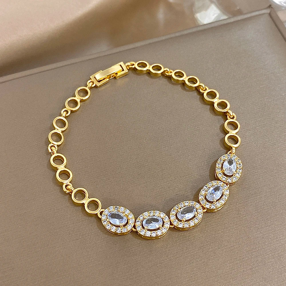 Gold-tone rhinestone oval-link bracelet with round stone accents