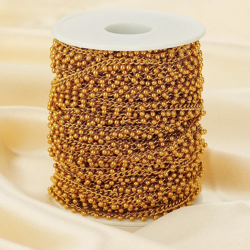 Gold beaded curb link chain spool with continuous small ball drop chain
