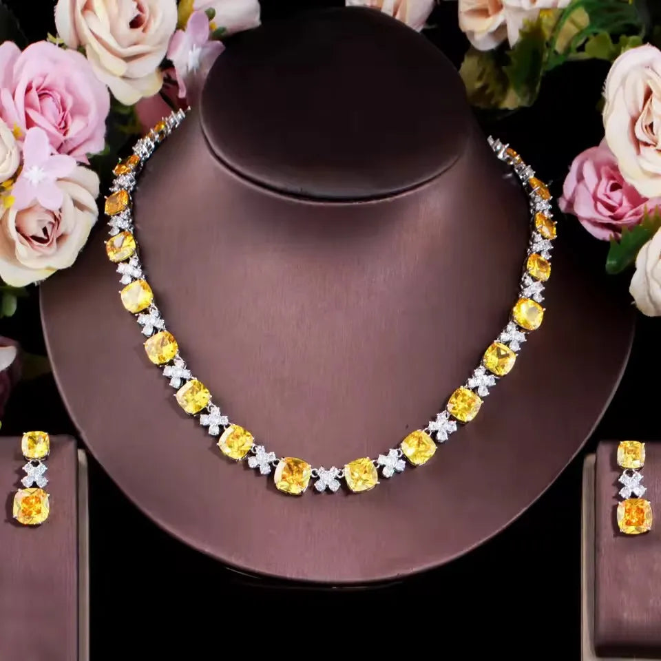 Yellow square zirconia necklace with matching square drop earrings set on jewelry bust