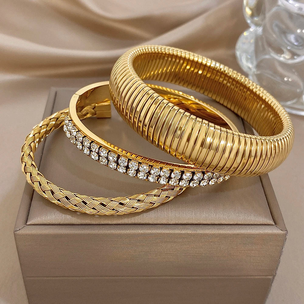 Gold-tone stacked ribbed cuff bangles with zircon pave bangle and braided charm bracelet