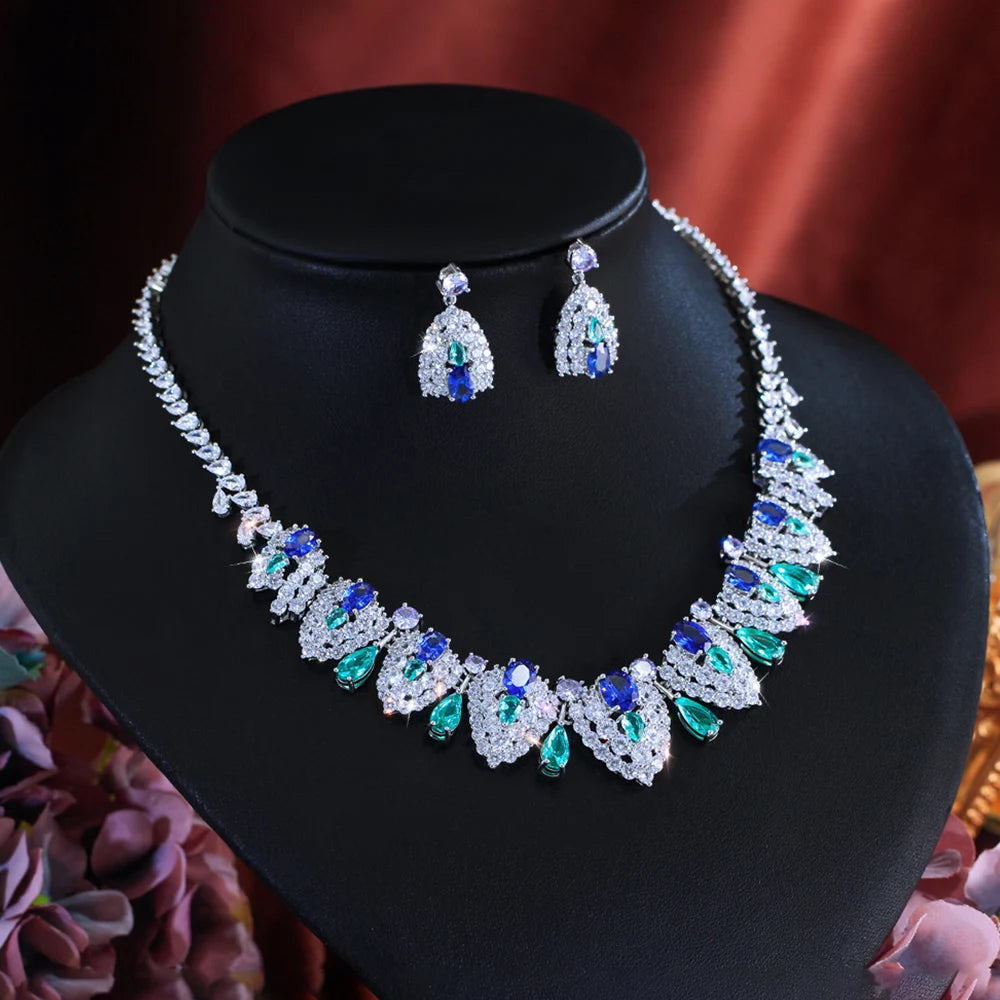 Silver-tone necklace and teardrop earrings with blue, green, and clear stones