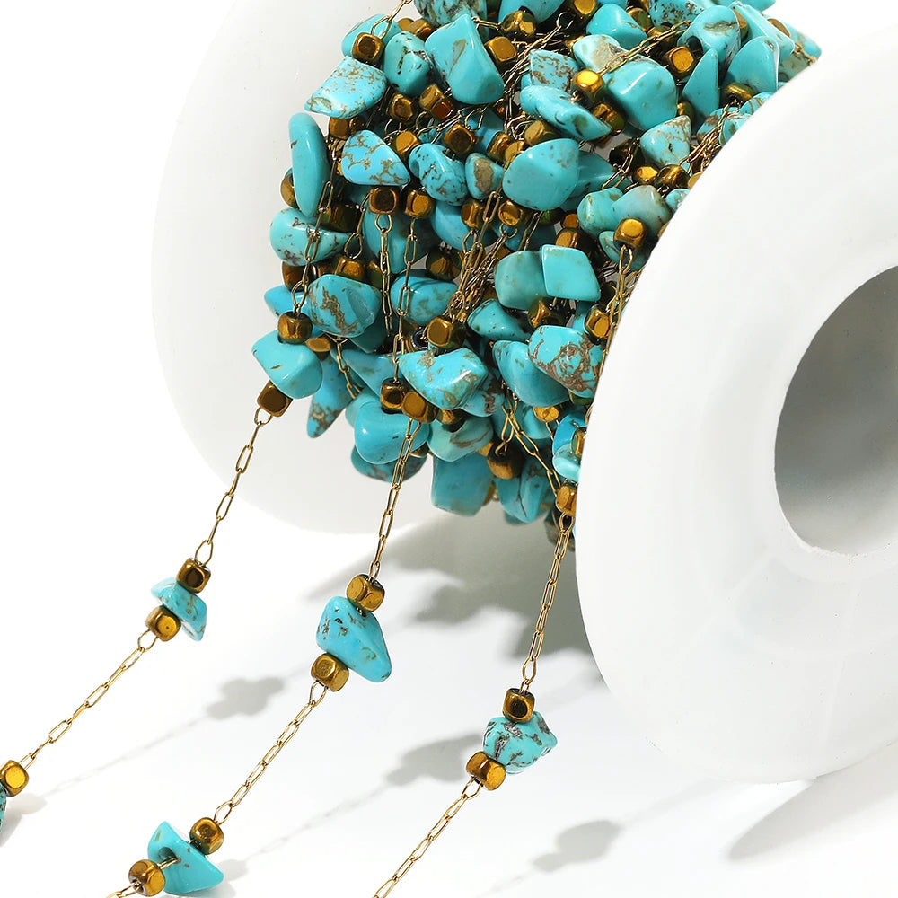 Close-up irregular glass bead link chain with turquoise stones and gold-tone clasp links