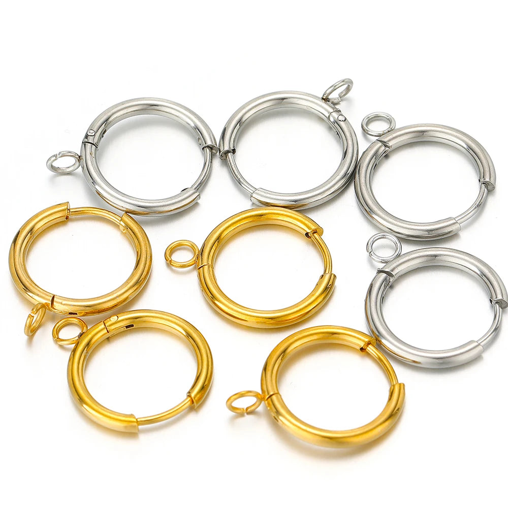 Assorted huggie hoop earring hooks in gold and silver tones, with loop posts and jump rings.