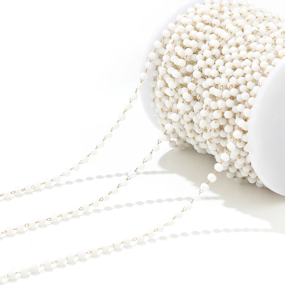 White pearl-like beaded necklace chain on a spool