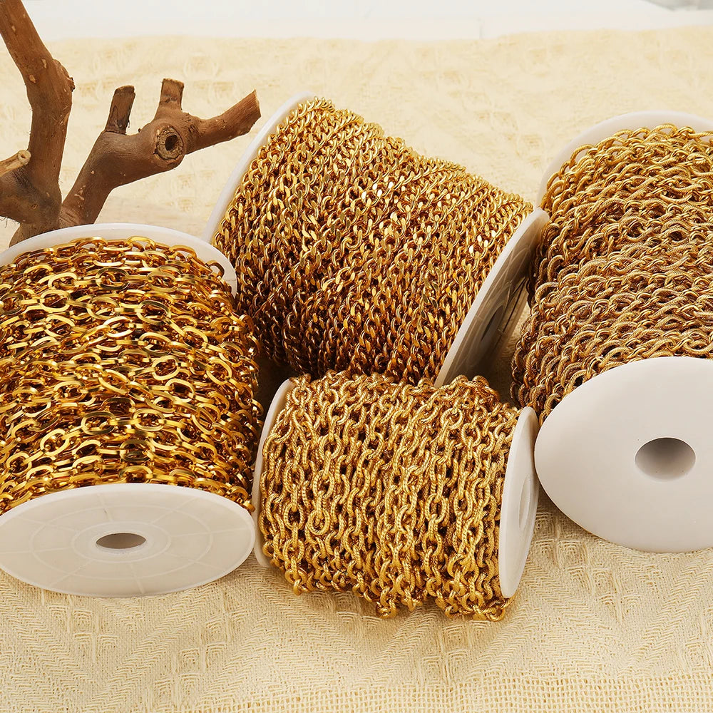 Gold Cuban link chain rolls on white spools, chunky chain links for DIY jewelry