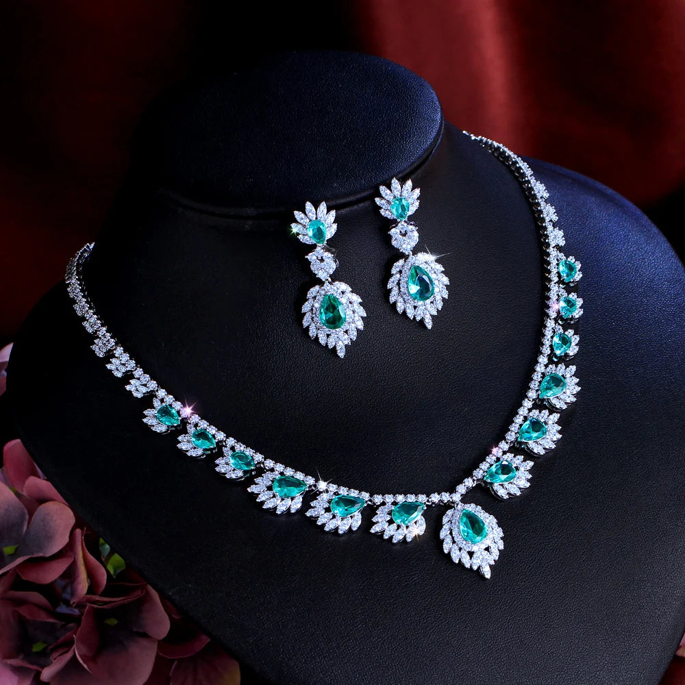 Teal oval and leaf motif necklace with dangling drop earrings, silver-tone look