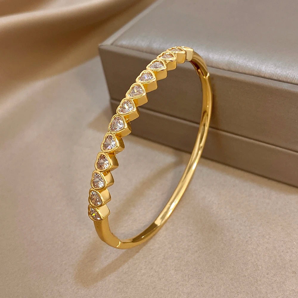 Gold-tone heart crystal inlay hinged bangle bracelet, front view
