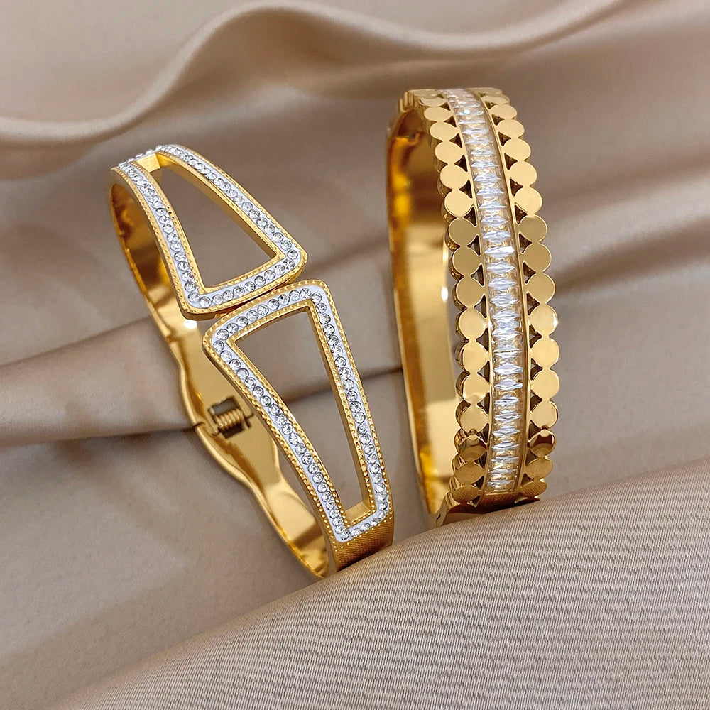 Gold-tone geometric cuff bangle with clear rhinestone inset and layered bead edges