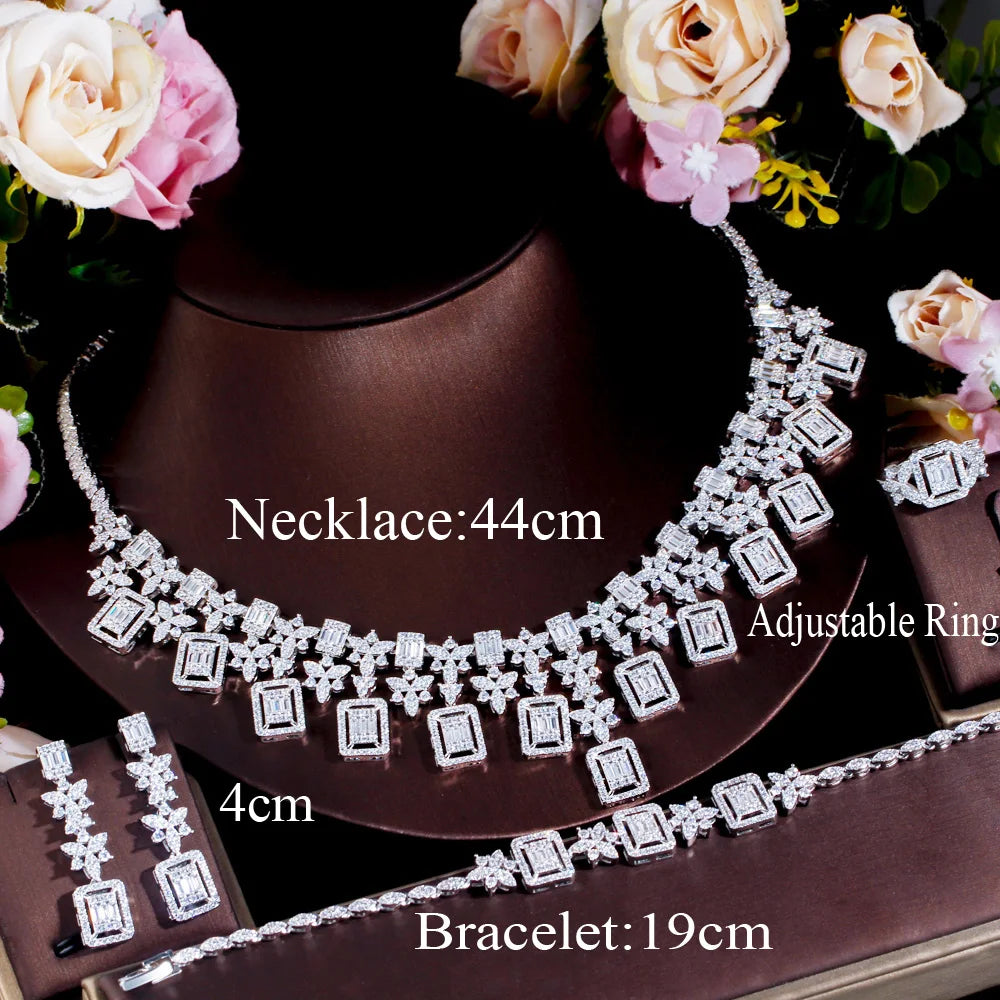 Rhinestone jewelry set on stand: statement necklace, bracelet, and ring, silver-toned