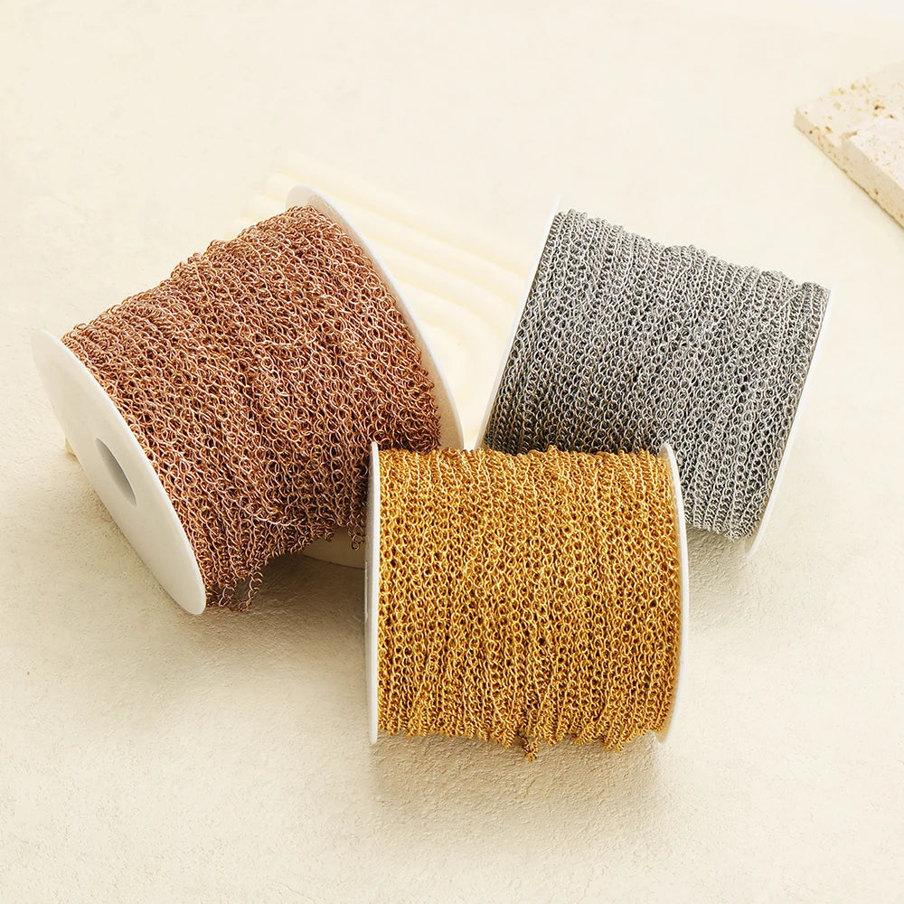 Three rolls of extension tail chain: copper, gold, and silver-gray linked loops