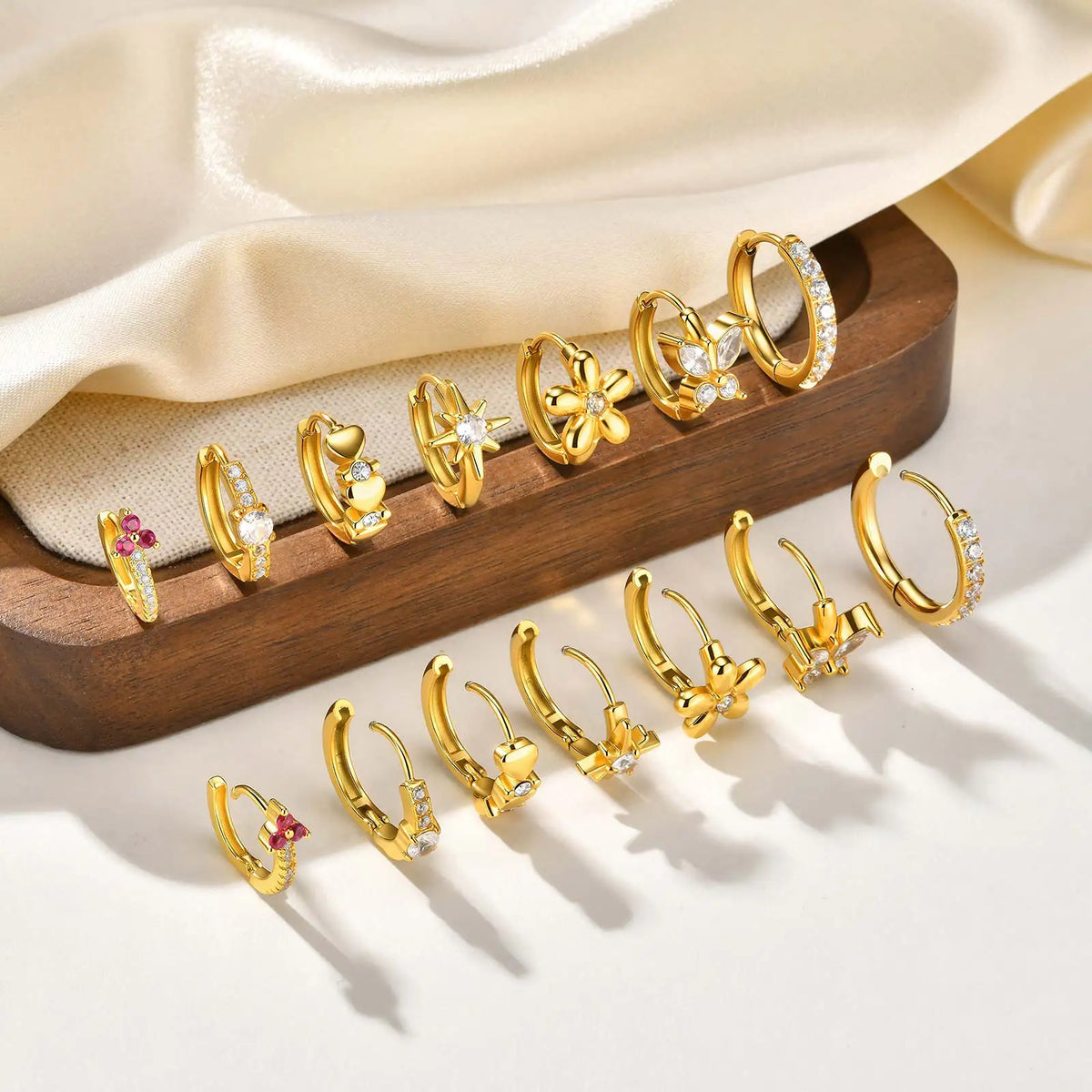 Gold-tone huggie hoop earrings with mixed clear CZ and pink accent stones