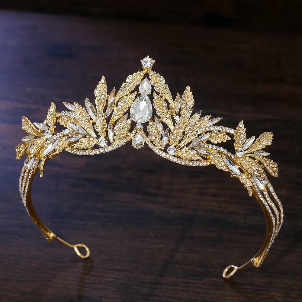 Gold rhinestone tiara headband with teardrop center stone and clear leaf details