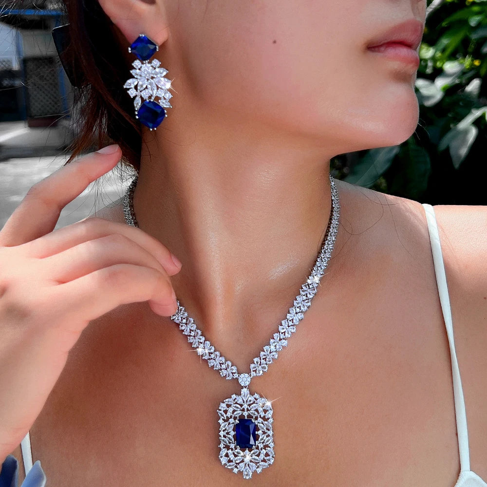 Cubic zirconia flower necklace and earring set with blue stones and silver-tone setting