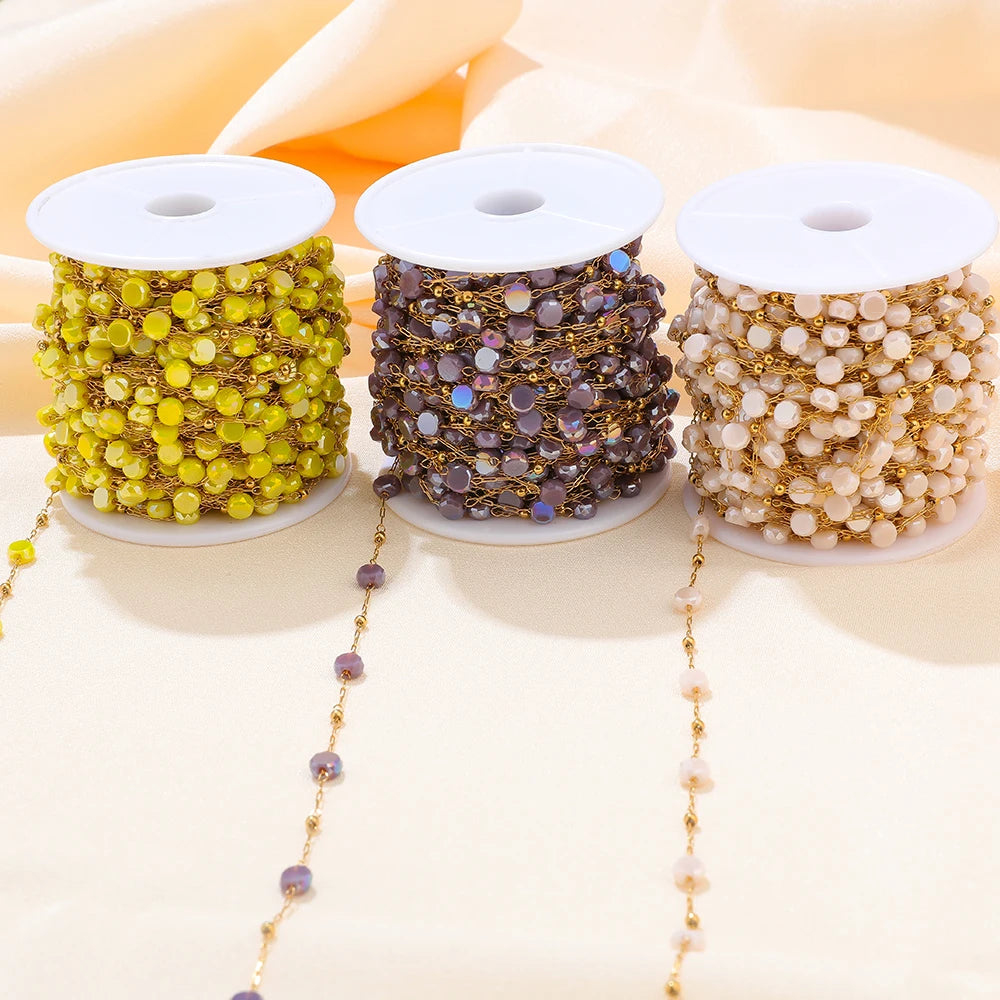 Three crystal bead chain spools in yellow, purple, and white with gold links
