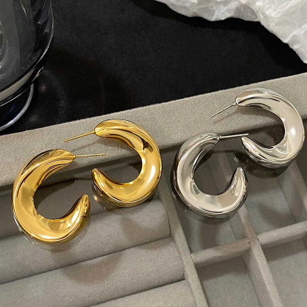 Gold- and silver-tone glossy chunky hoop earrings shown in pairs