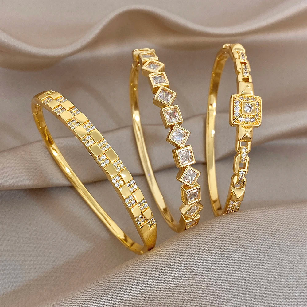 Gold-plated cuff bangles with square zirconia links, geometric center accents