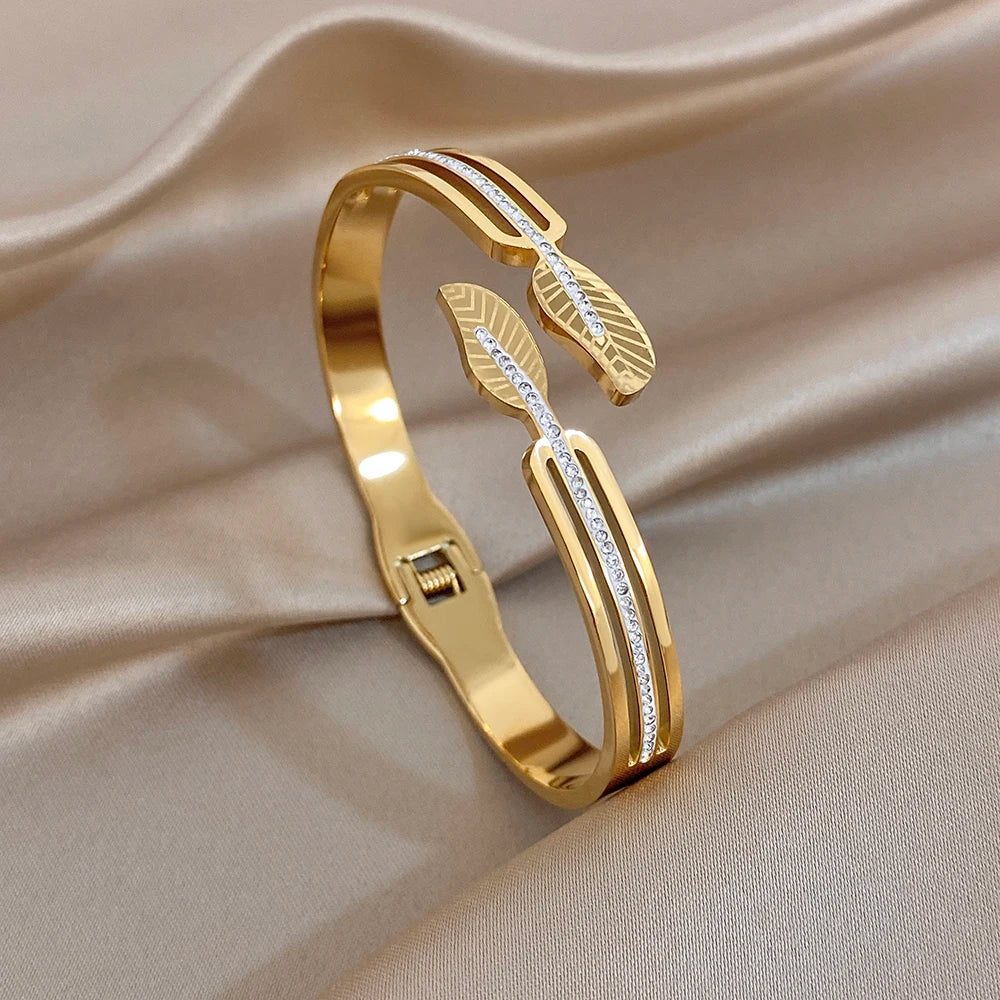Gold-plated cuff bracelet with leaf detail and clear zircon stones