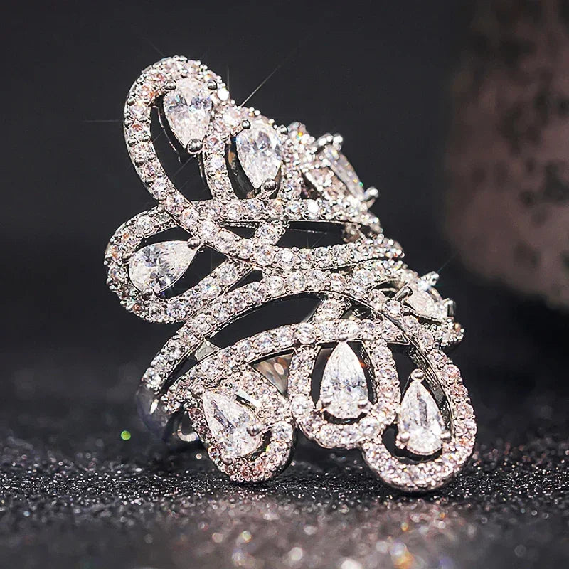 Silver-tone cubic zirconia hollow filigree ring with teardrop stones