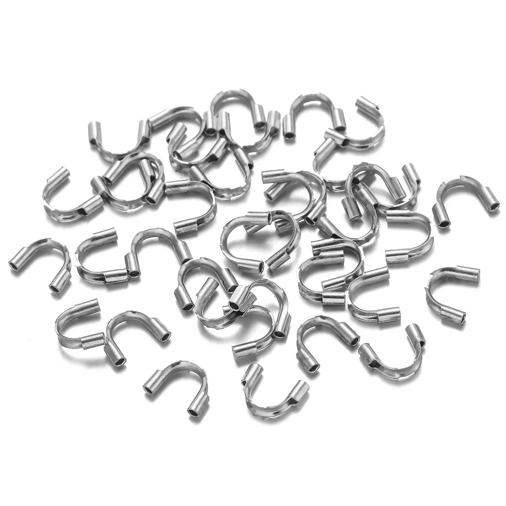 Stainless steel U-shaped wire protectors, small connector clasps in mixed pile