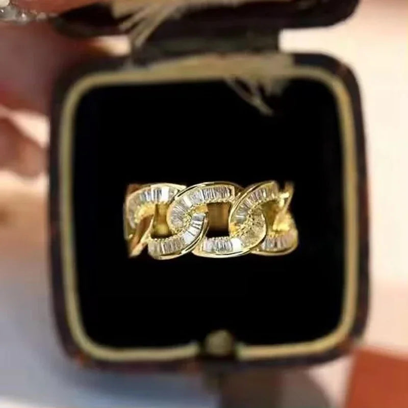 Gold-tone chain-link cubic zirconia ring in jewelry box, front view