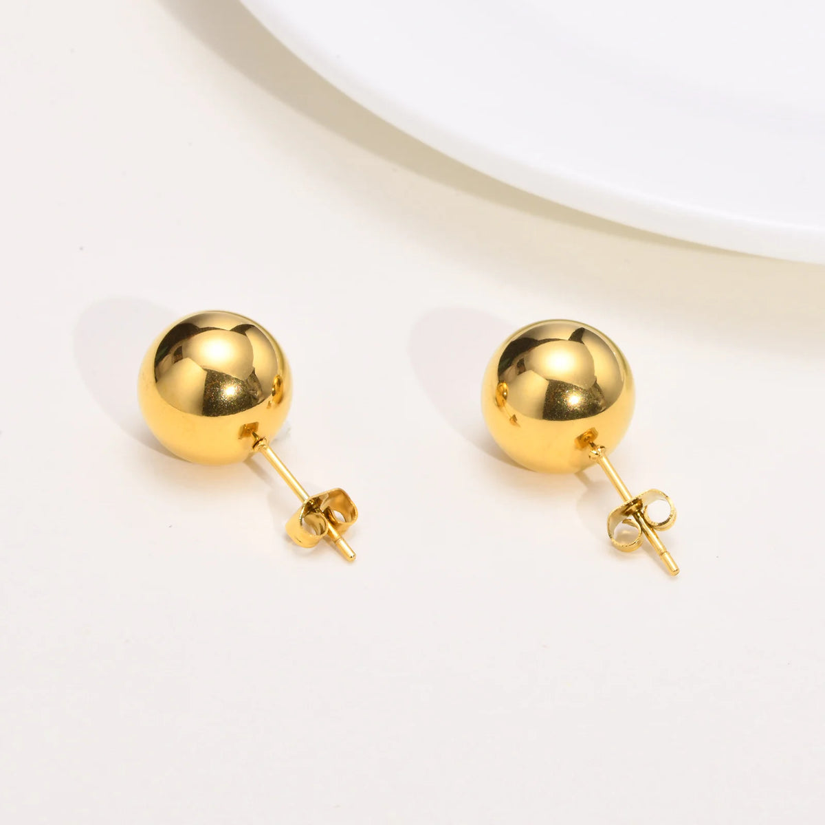 Pair of polished gold-tone ball stud earrings with posts and butterfly backs