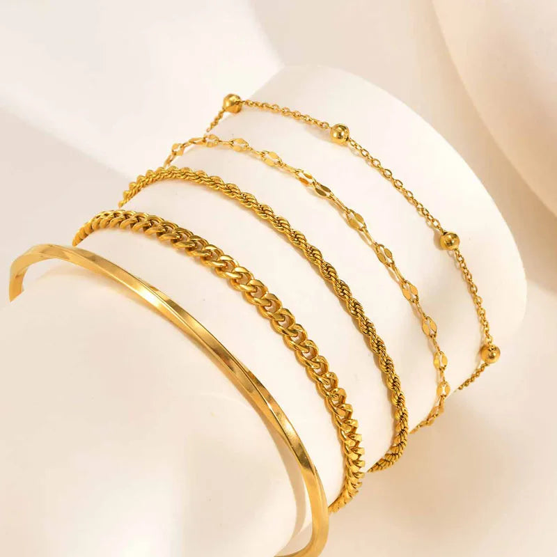 Gold tone chain stack bracelets with thin cuff bangle and lobster clasp ends