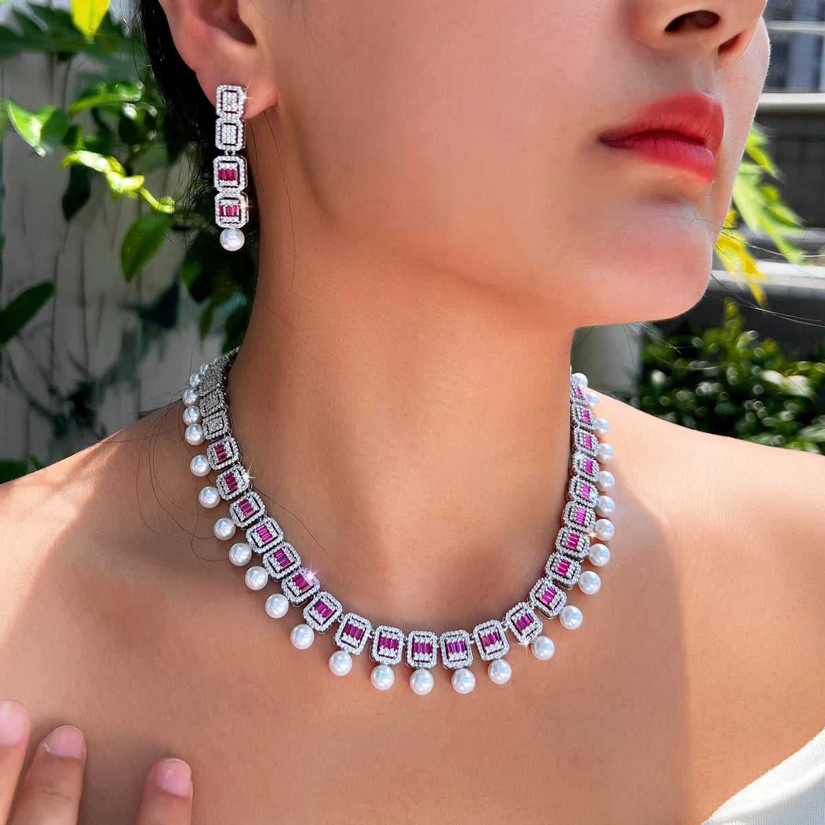 Geometric CZ necklace with rose accents and white pearl beads, plus matching drop earrings