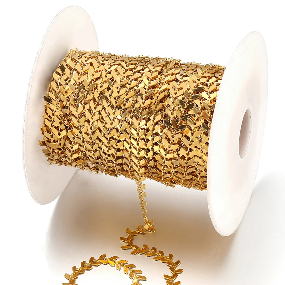 Gold airplane arrow link chain on a spool, glossy embossed arrow connectors