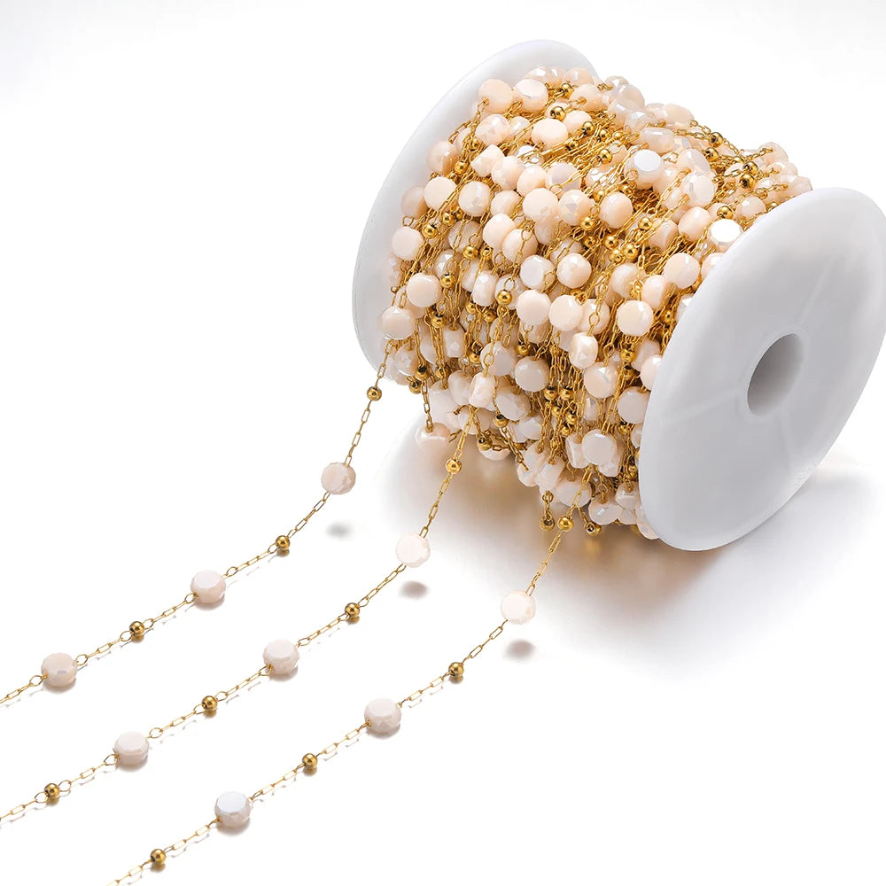 Light pink crystal bead chain with gold links on a white spool for DIY jewelry