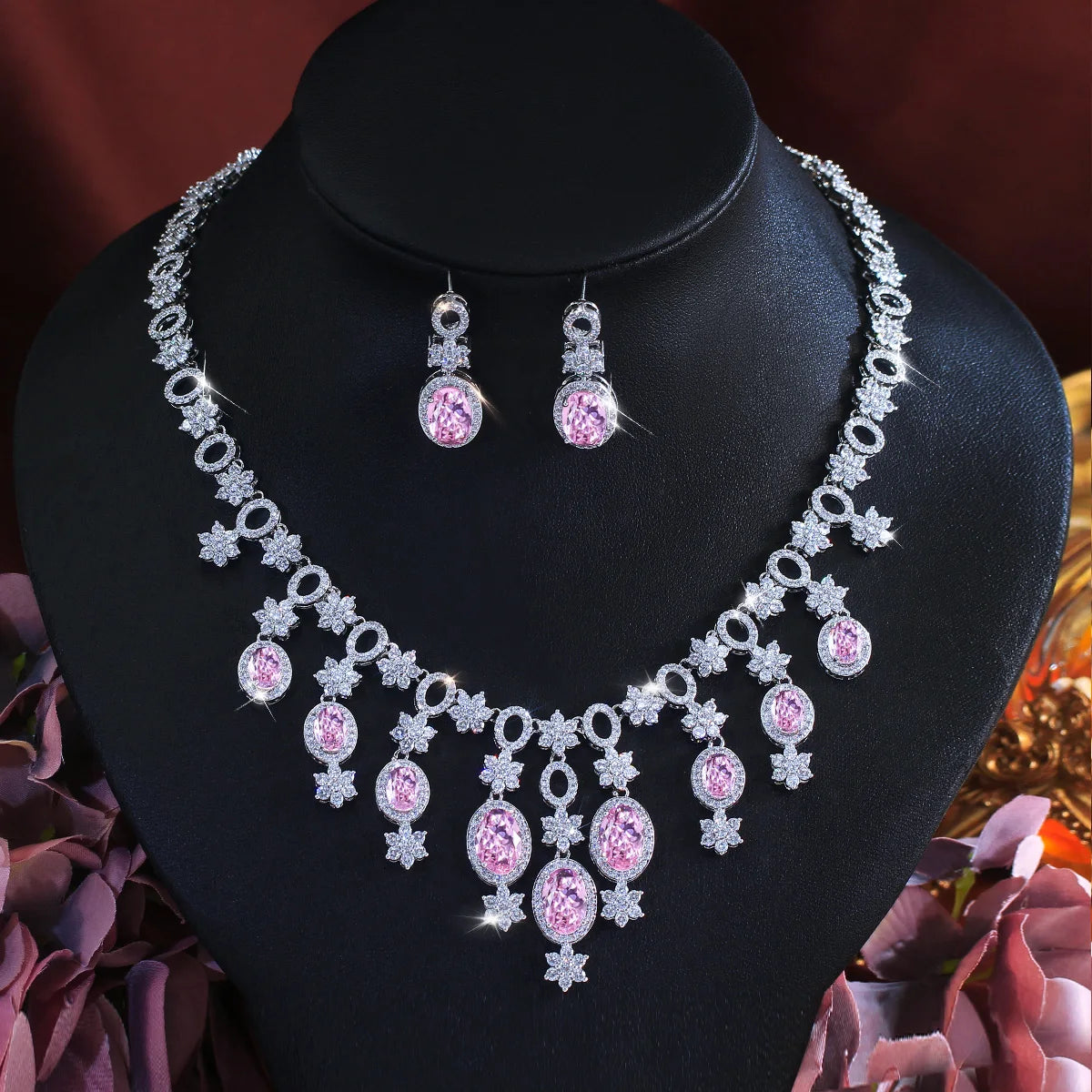 Pink oval stone necklace and matching drop earrings with silver-tone floral crystal details